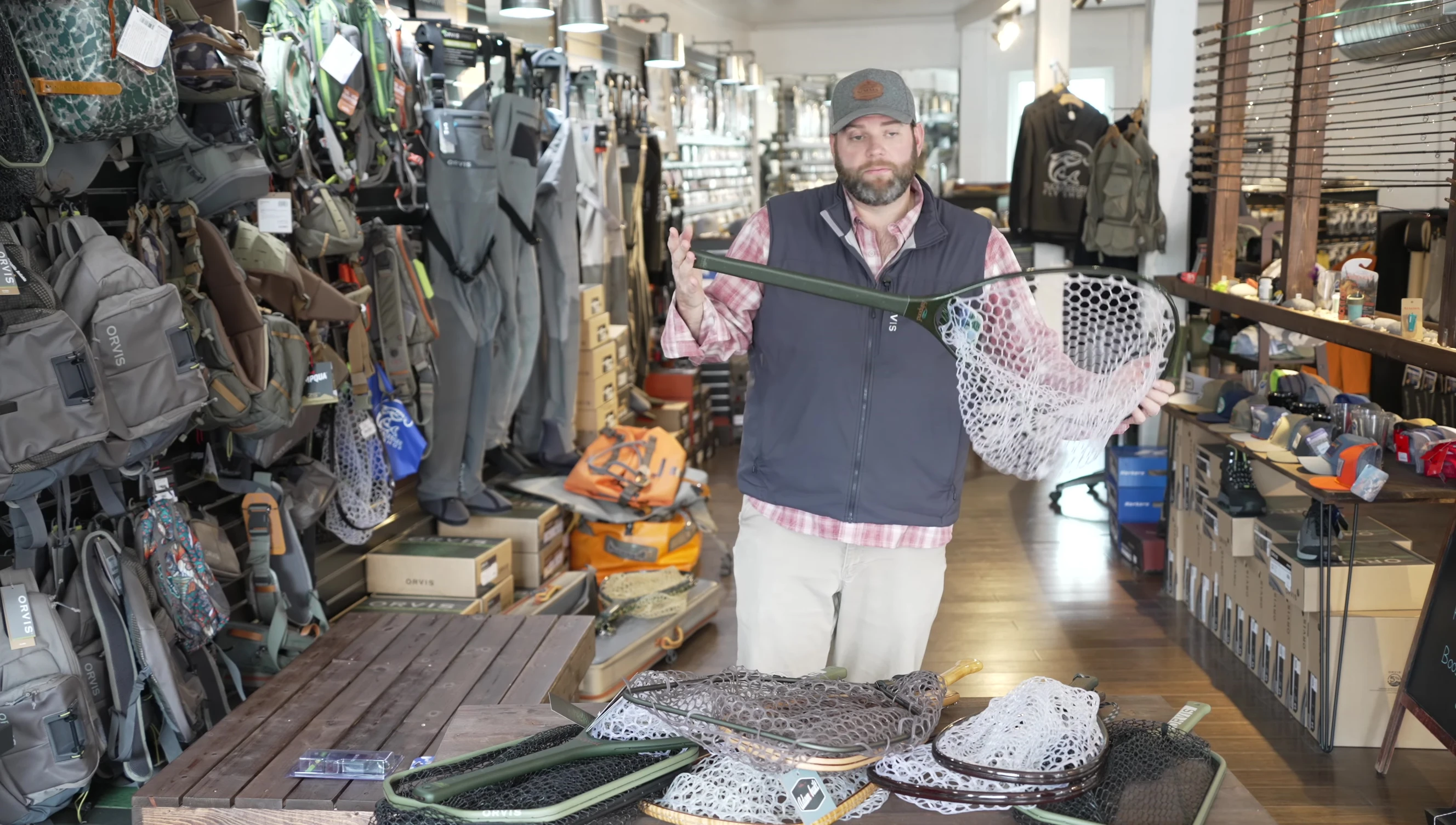 Demonstrating the reach of a long-handled net.