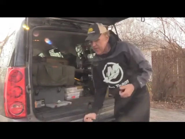 The narrator landing a fish using the Bear Claw net.