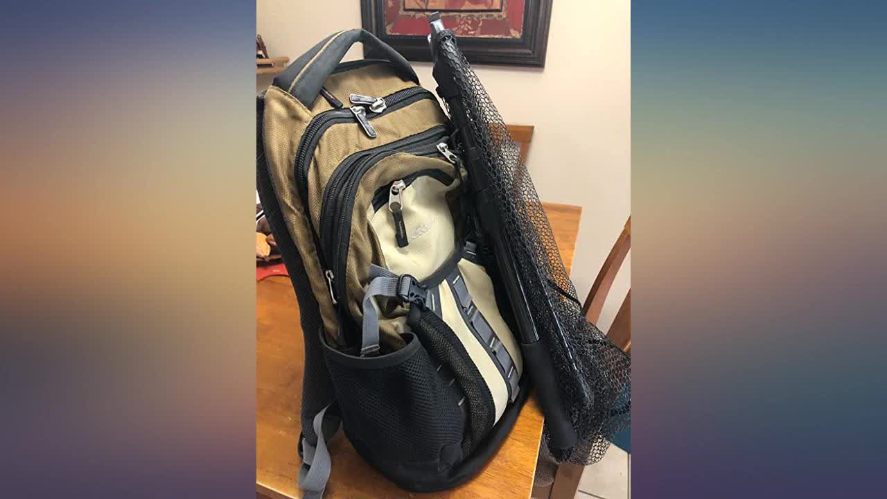 The compact net folded and attached to a fishing bag.