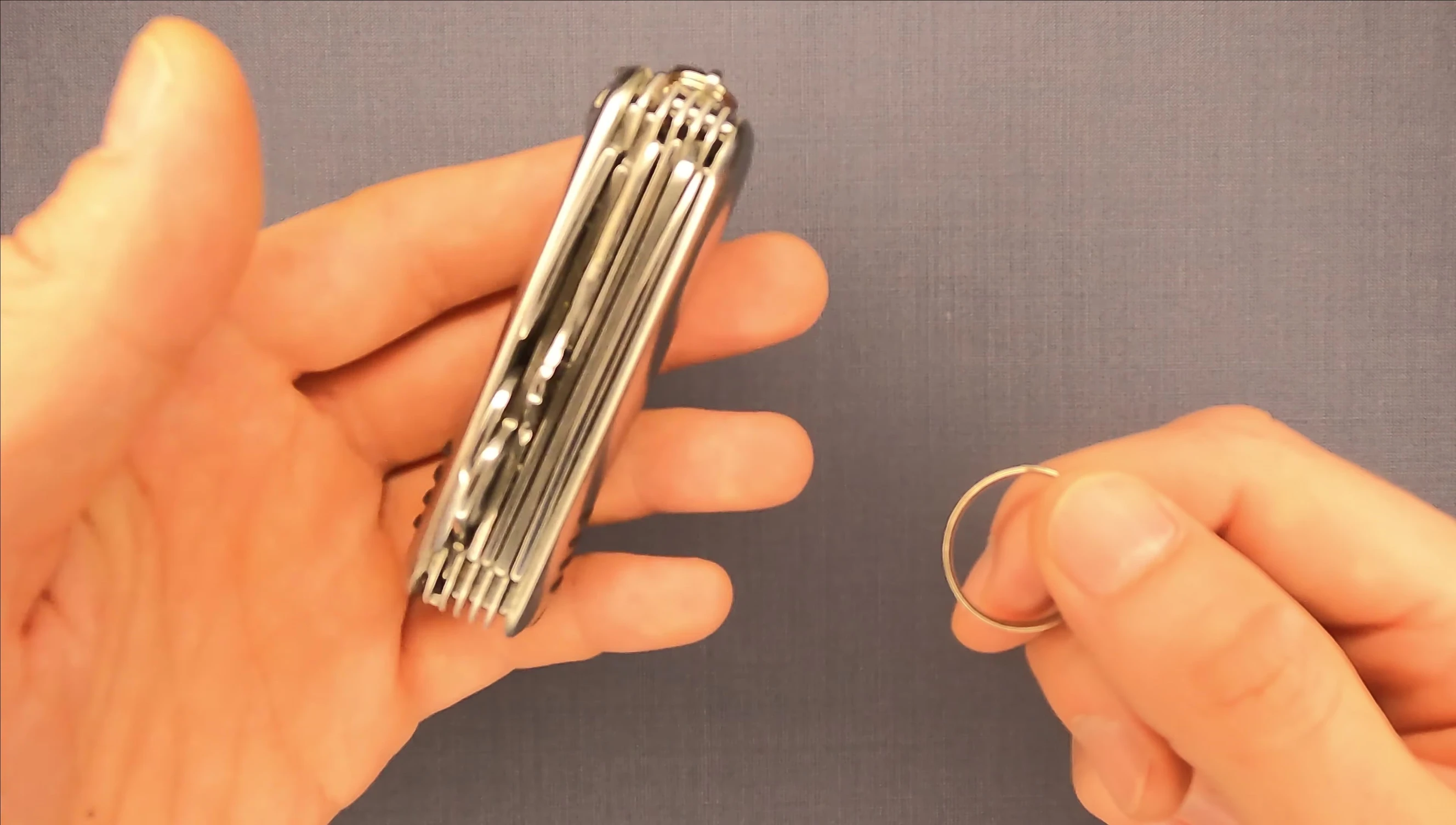 The tool holding a heavy pocket knife.