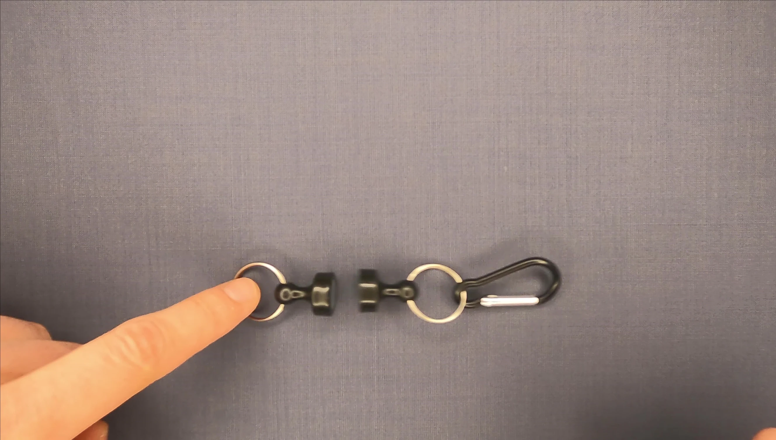 Demonstration of how to attach the tool to a backpack.