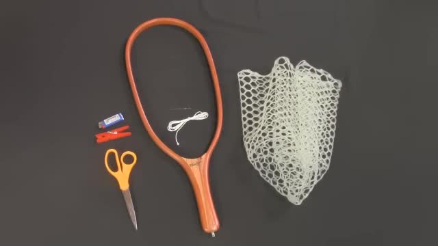 Close-up of the necessary tools: scissors, Dacron cord, and tapestry needle.