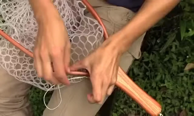 Tying the half hitches to secure the last loop.