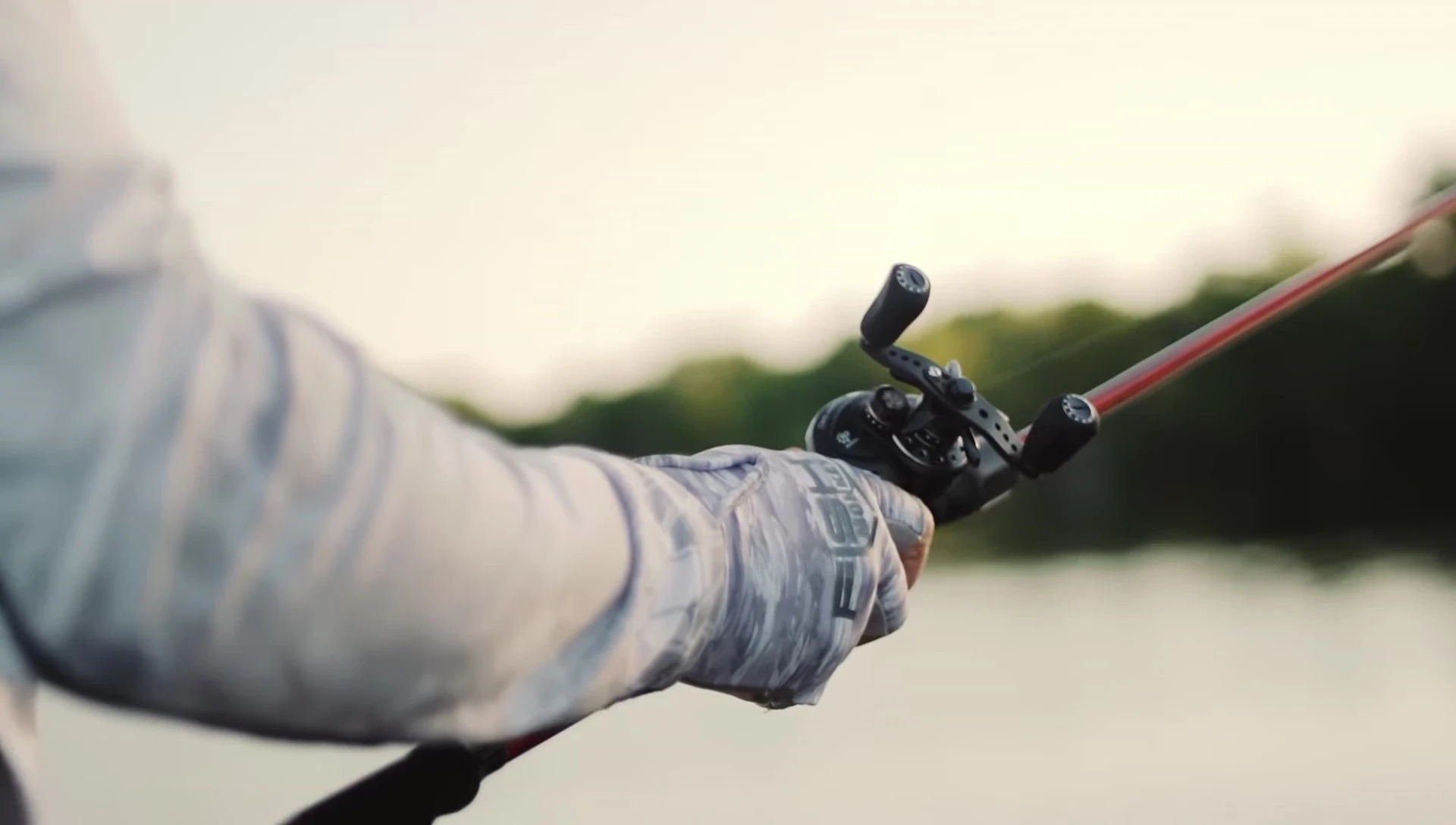 Angler using the Stubby Guide Glove while fishing.