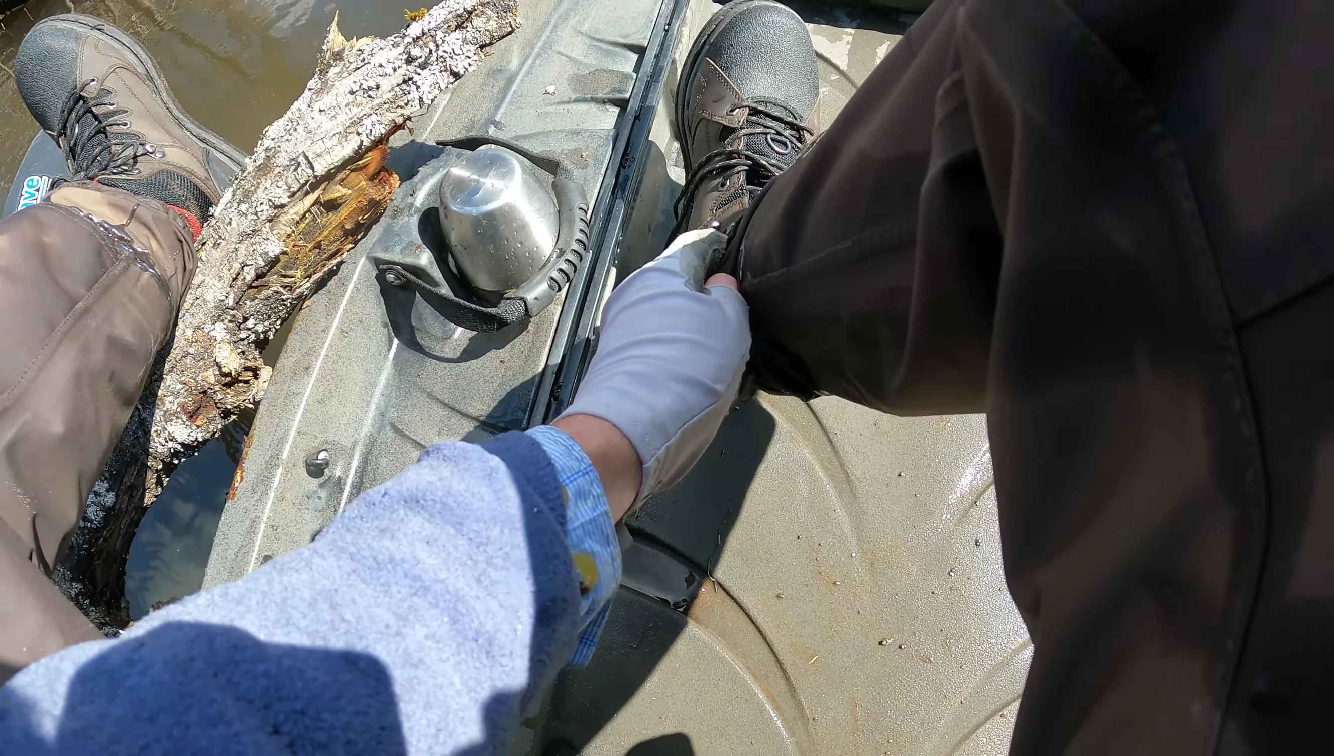 The reviewer demonstrating the ease of removing the boot due to the low-placed laces and large eyelets.