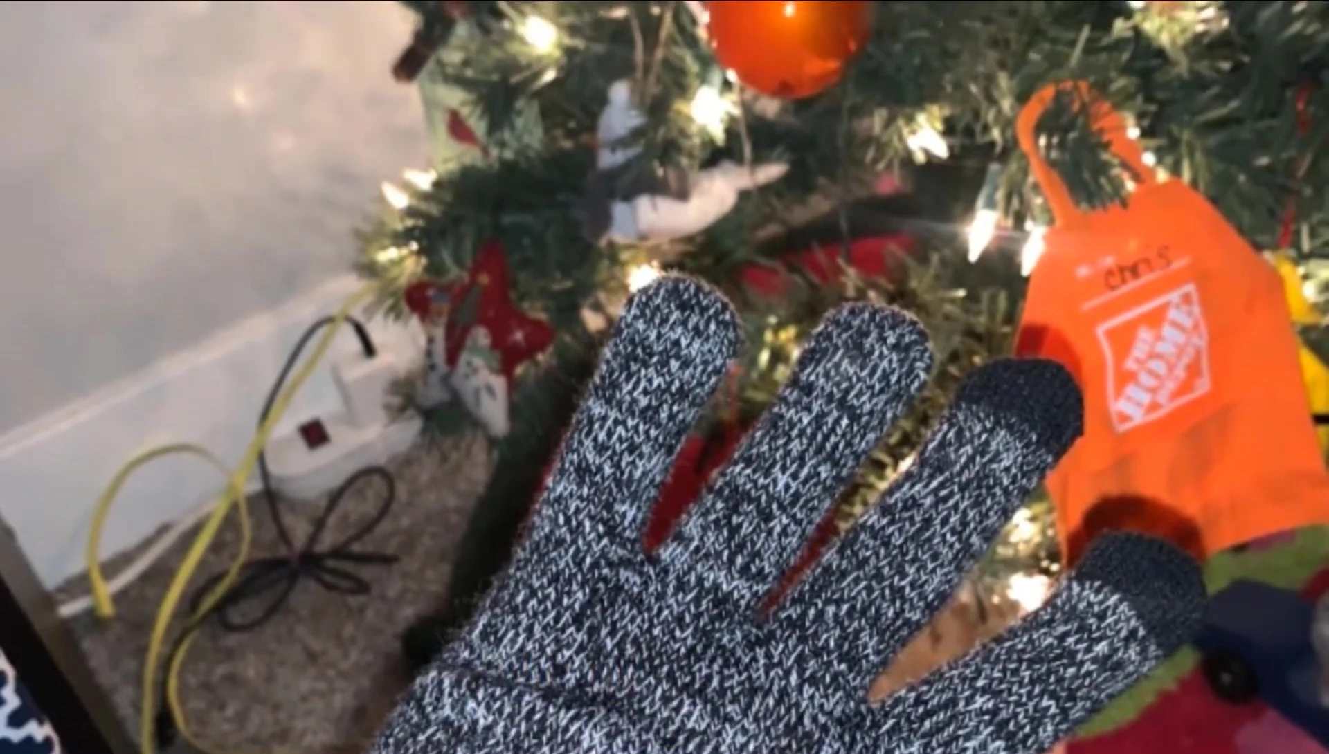 Person using touchscreen phone while wearing Jew Winner Nick gloves.
