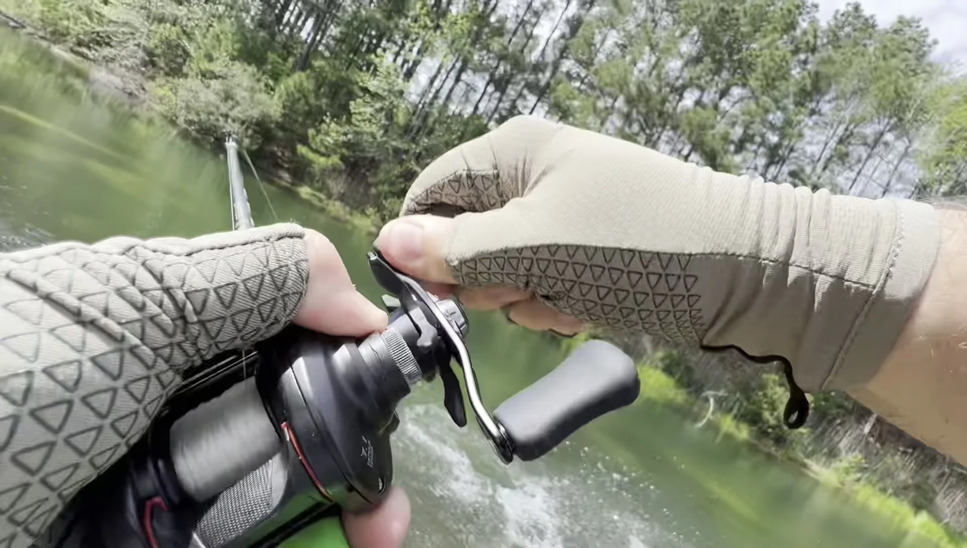 The reviewer excitedly holding the largemouth bass he caught.