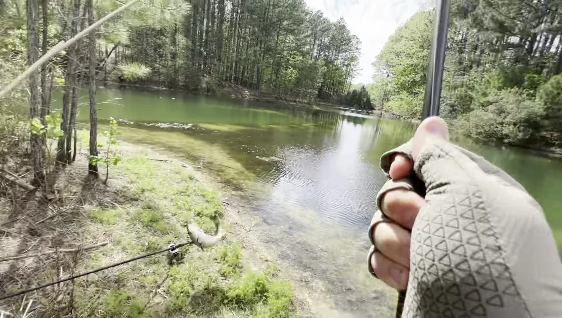 The reviewer successfully catching a fish while wearing the gloves.
