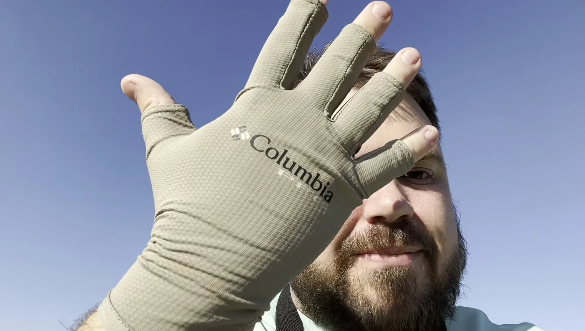 Close-up shot of the KITH x Columbia PFG fishing gloves in hand.
