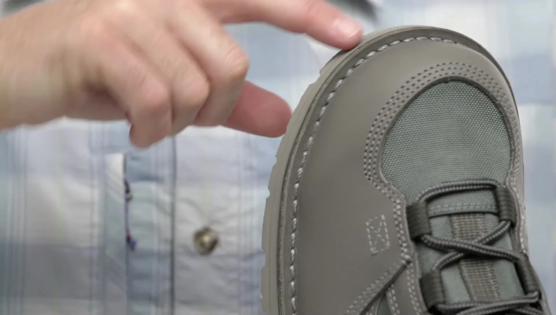 Detailed view of the stitched-down construction of the sole.