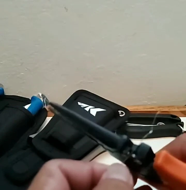Another shot of a lower-quality pliers failing to cut the fishing line