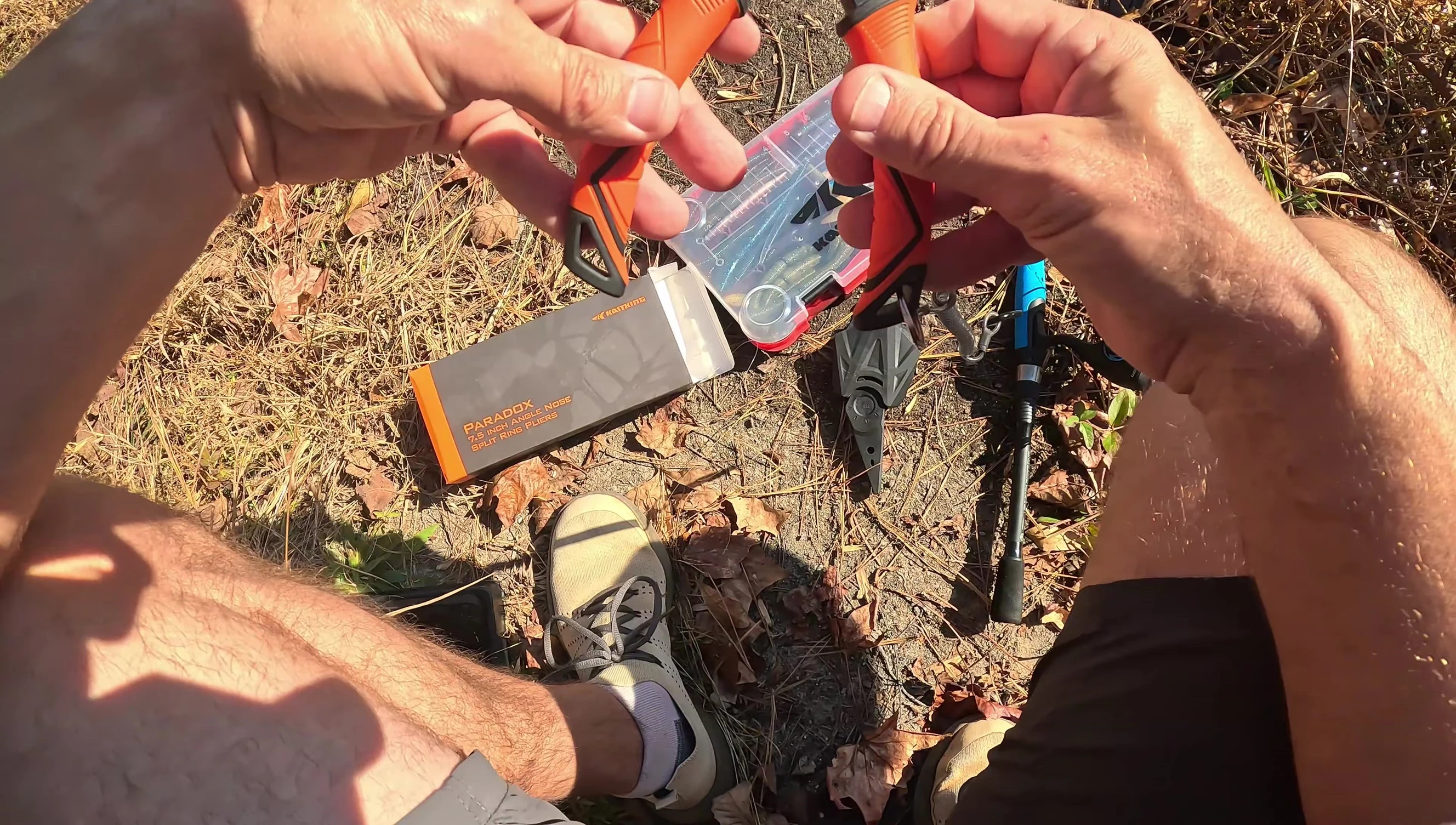 Using the pliers to cut fishing line.