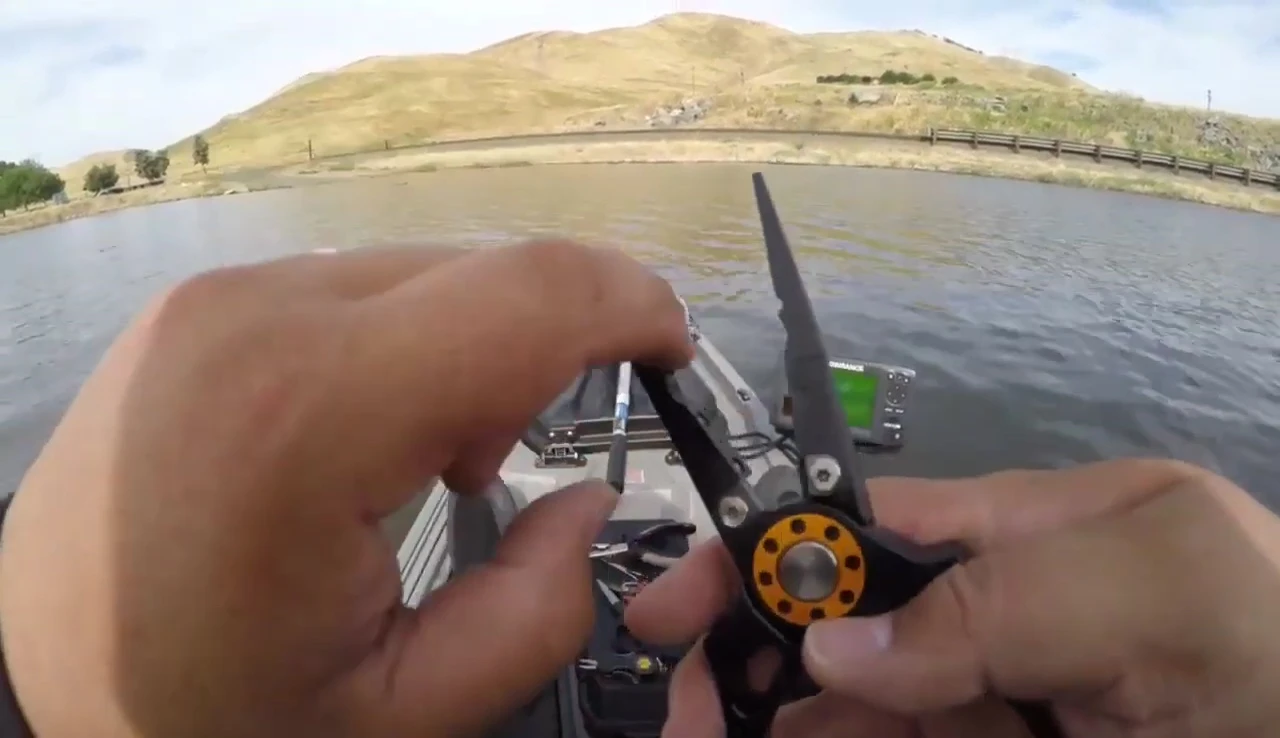 The pliers removing a hook, emphasizing the low profile.