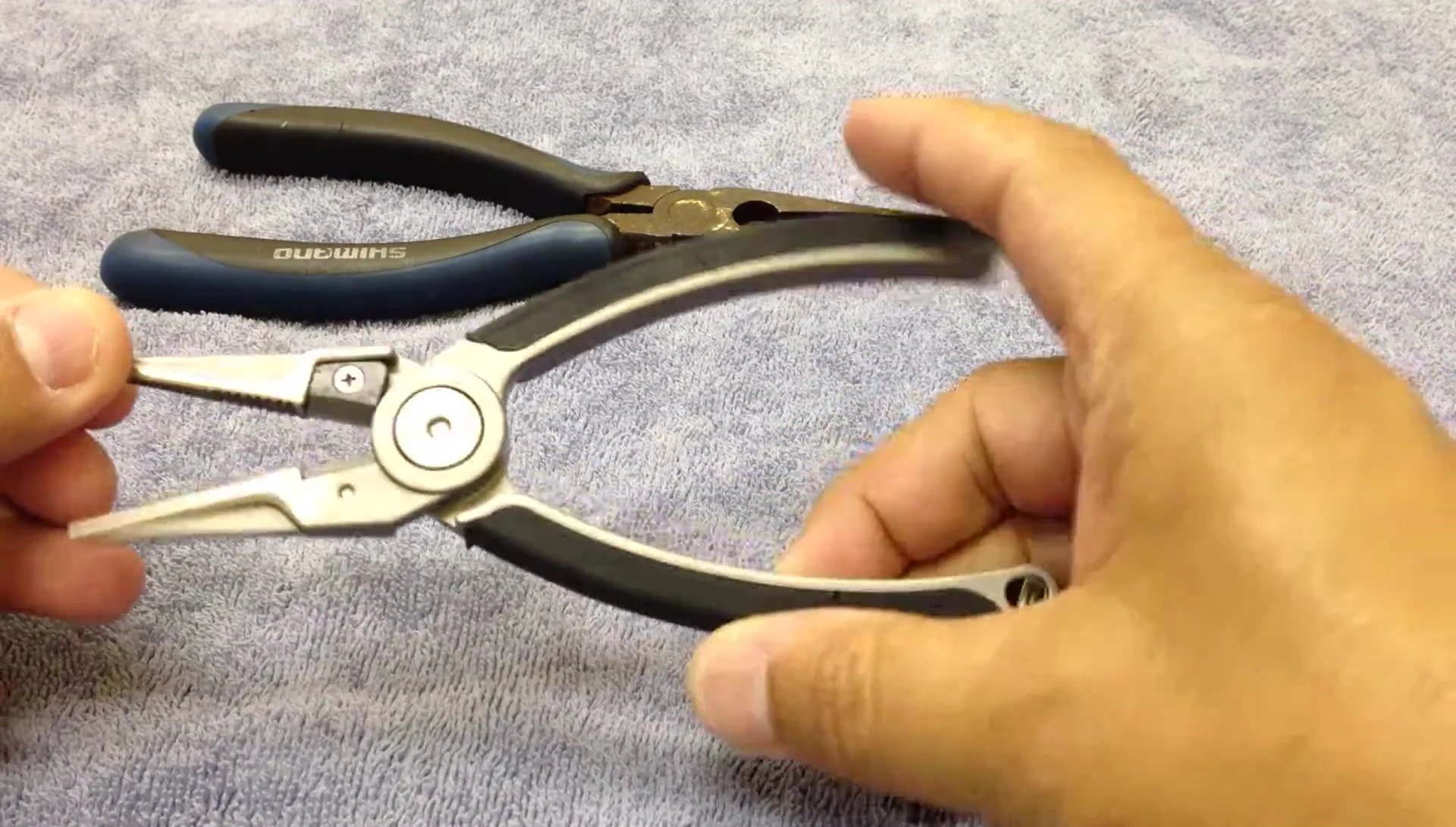 The speaker holding and showing the Donnmar 850 EX pliers.