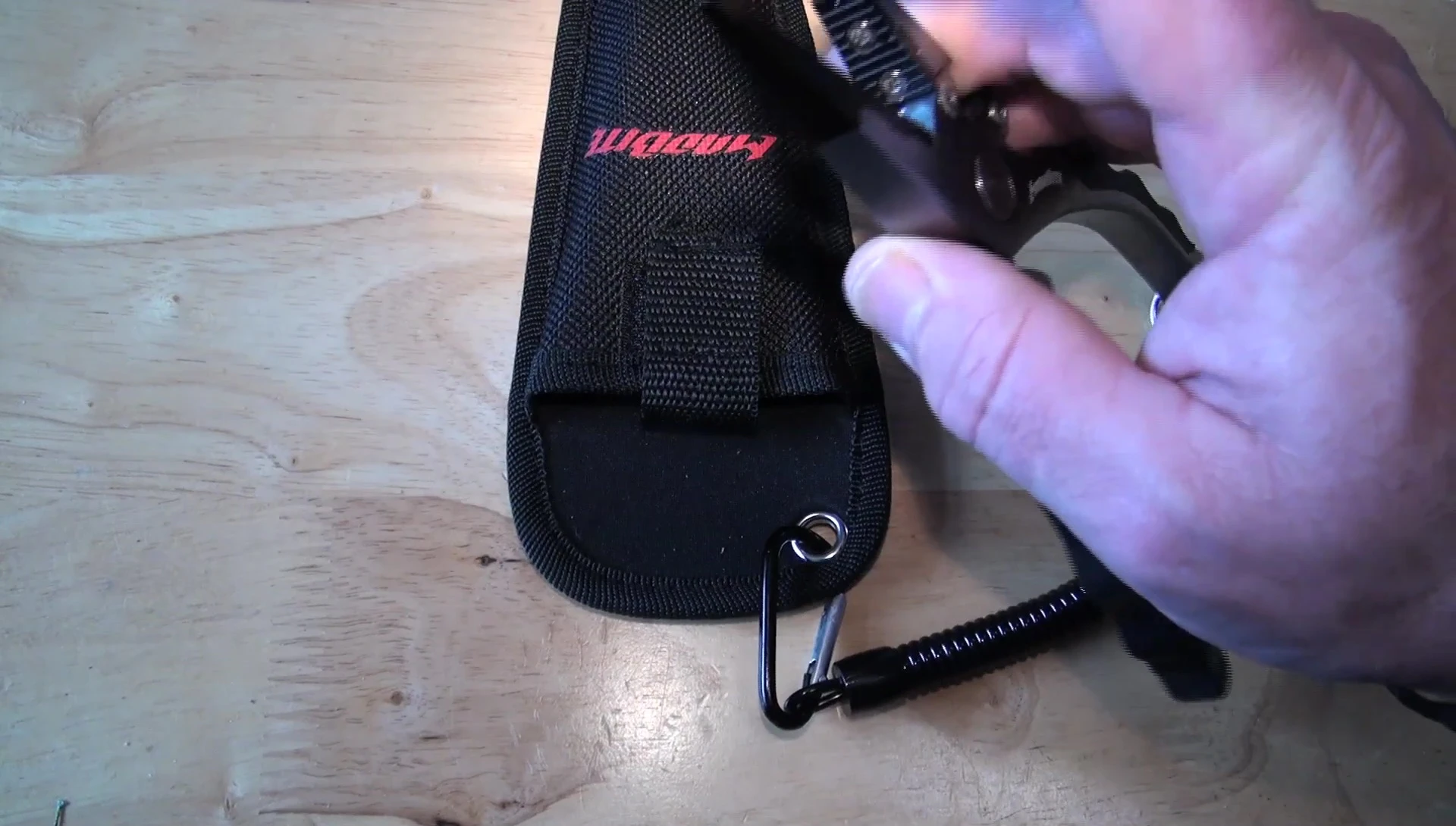 Comparison of the MadBite pliers with another pair featuring a split ring opener