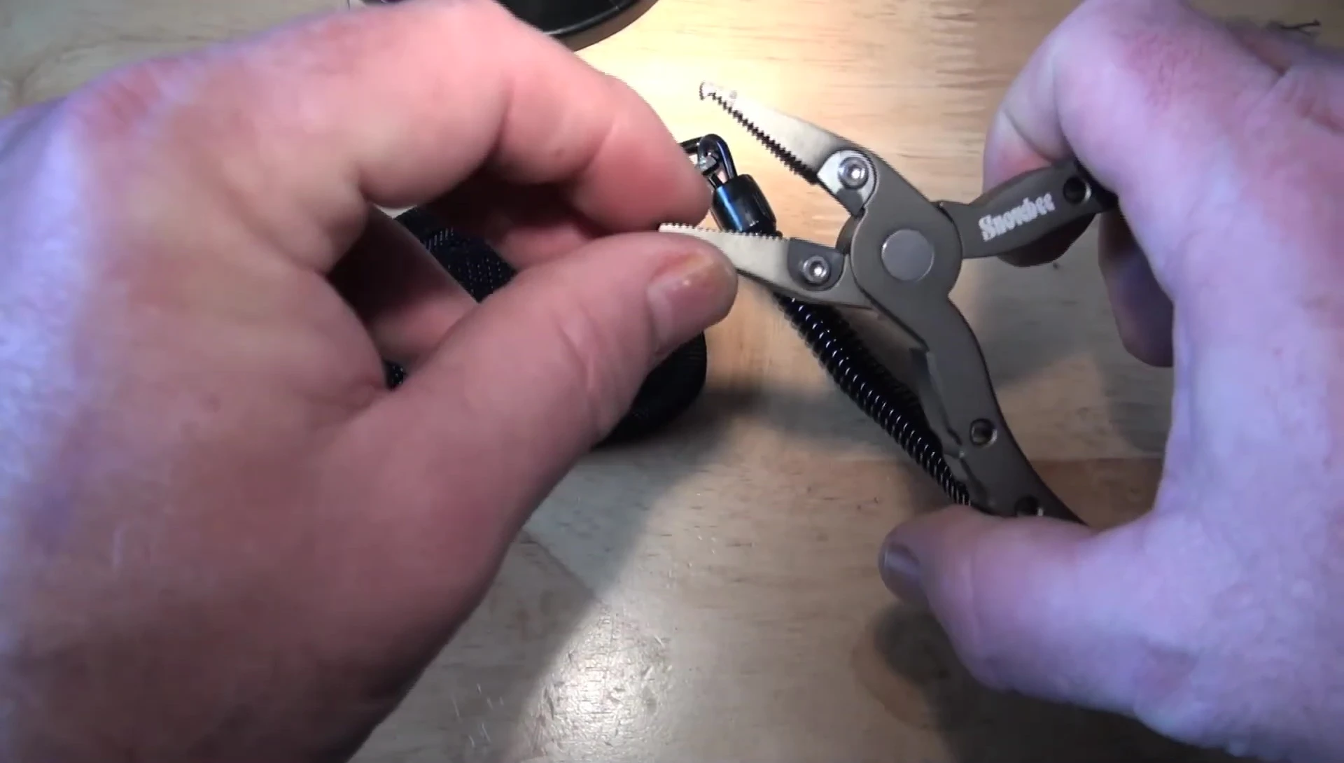 The reviewer demonstrating crimping with the Snowbee pliers