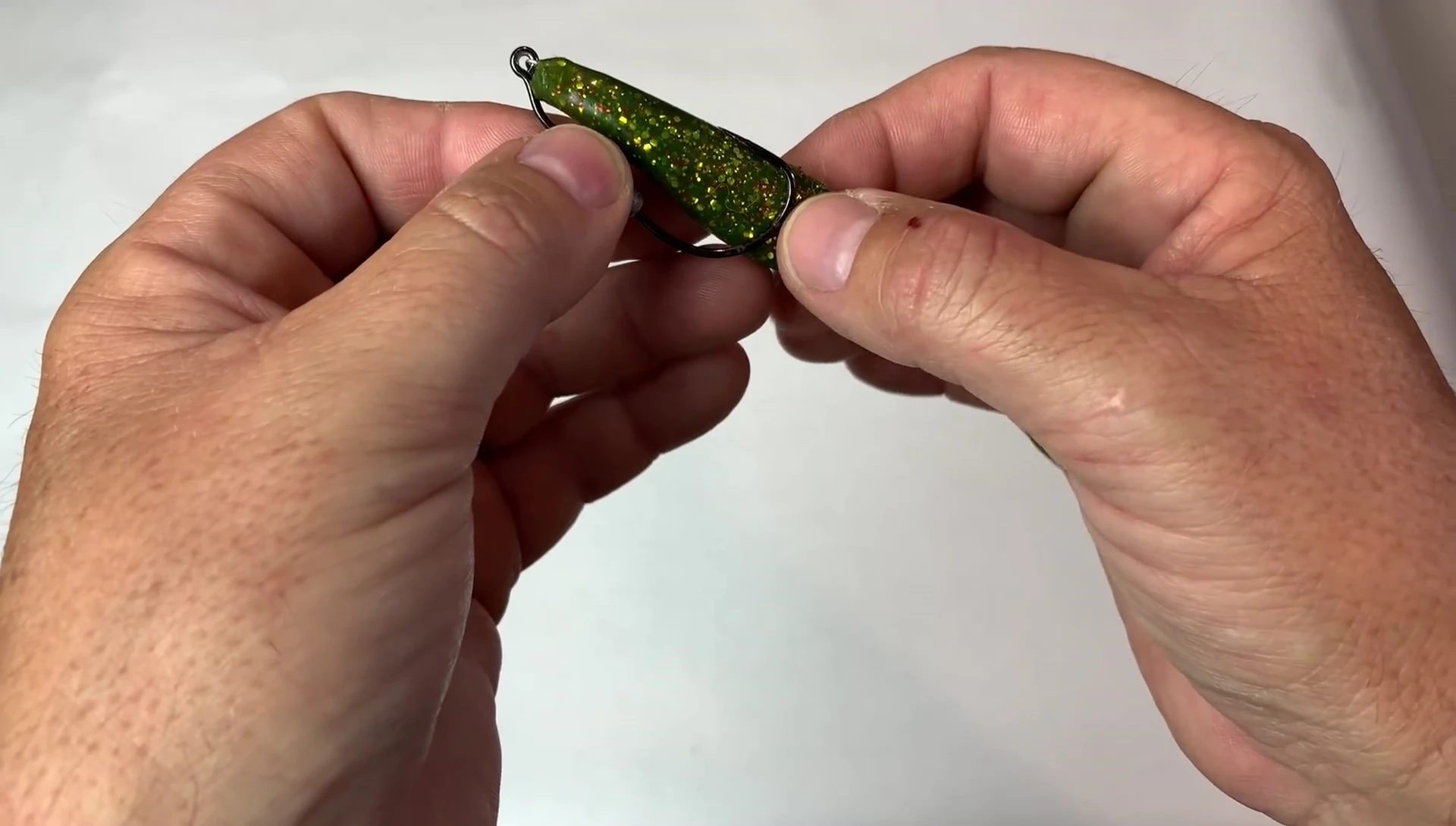 Inserting the hook into the lure.