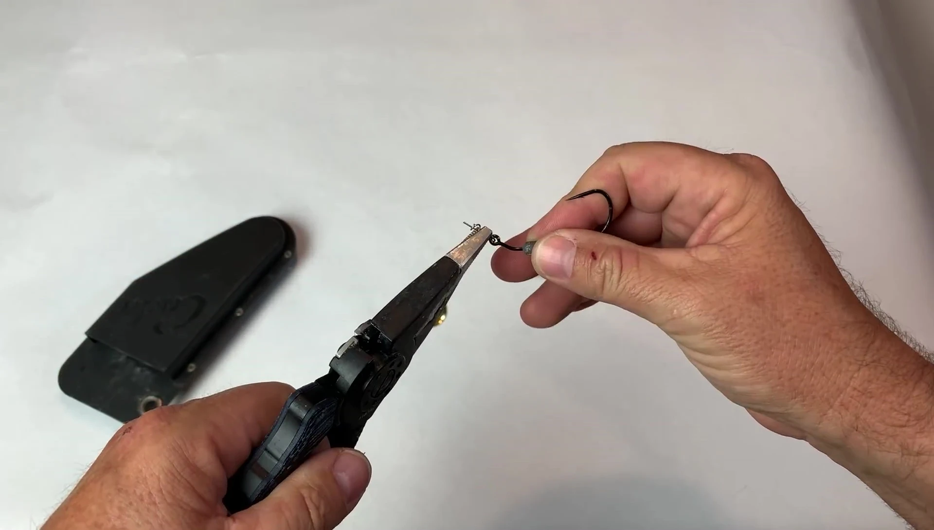 Removing the hook from the twist lock mechanism.
