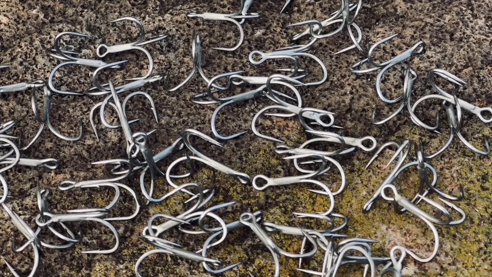Close-up of Mustad Jaw Lok treble hooks showcasing their lightweight design.