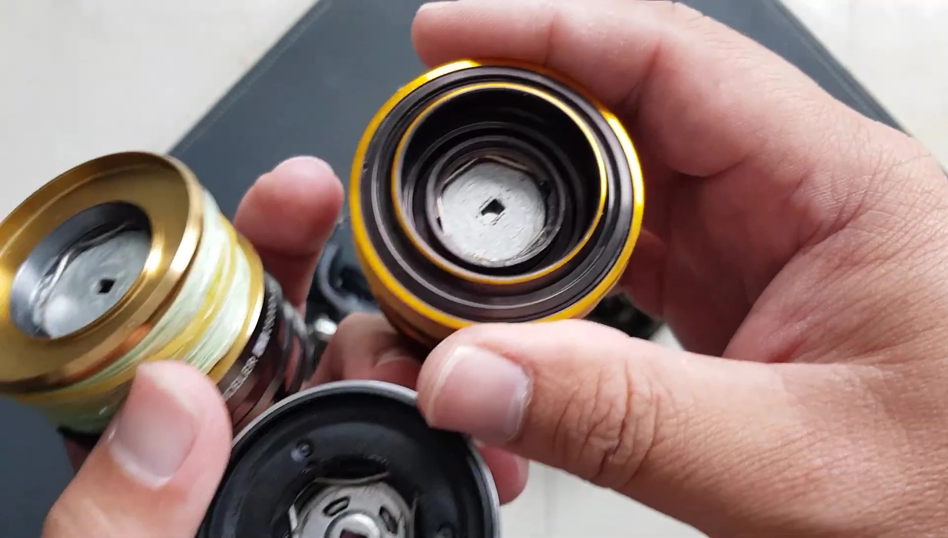 The speaker mentions the carbon fiber washers in the Daiwa BG reel