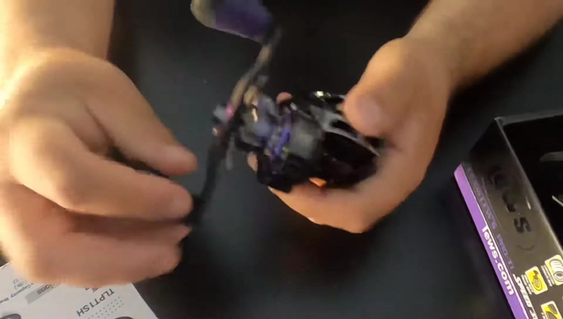 The reviewer demonstrating the smoothness of the reel's handle.