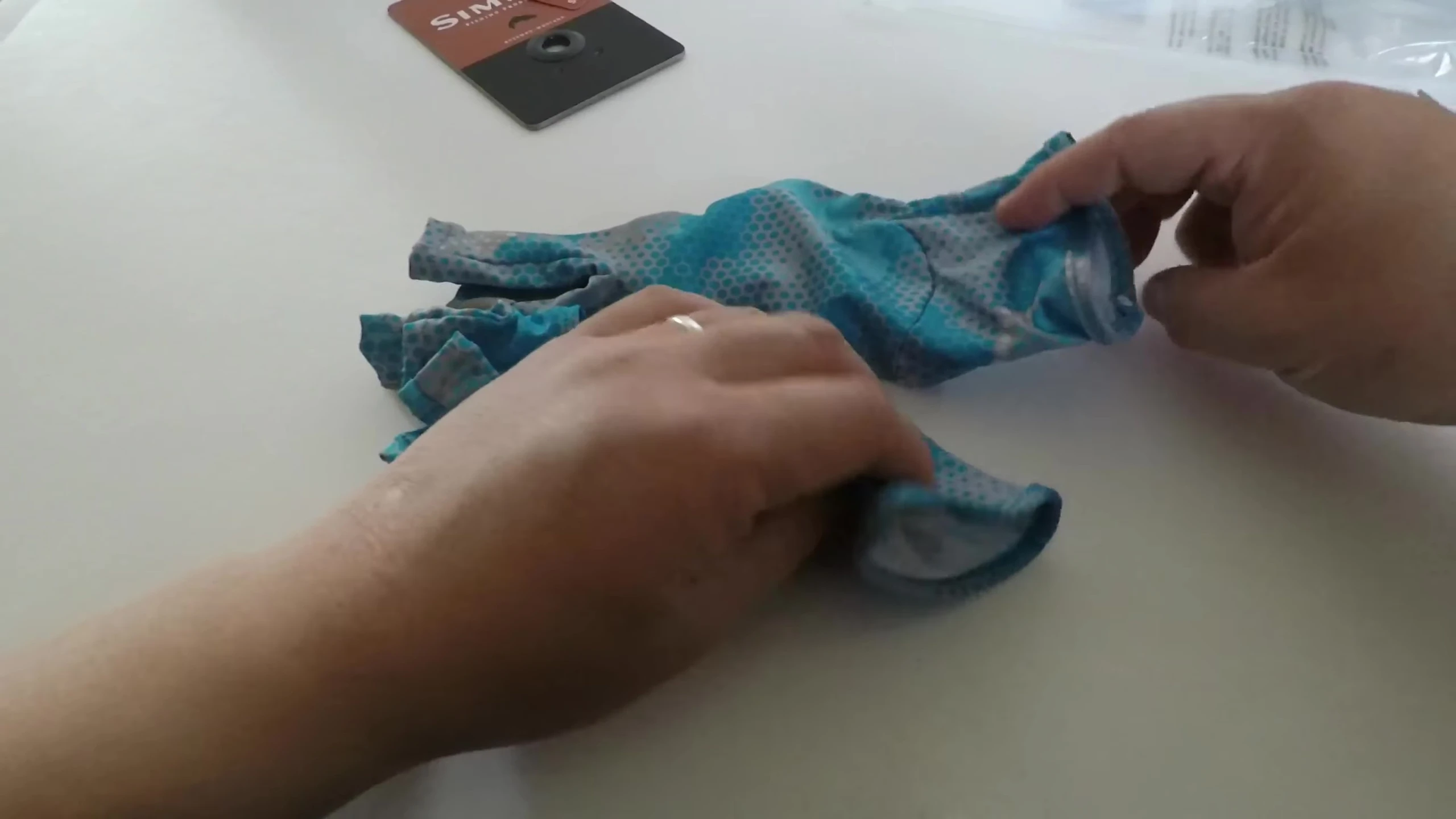 Showing the mechanism to clip the gloves together.