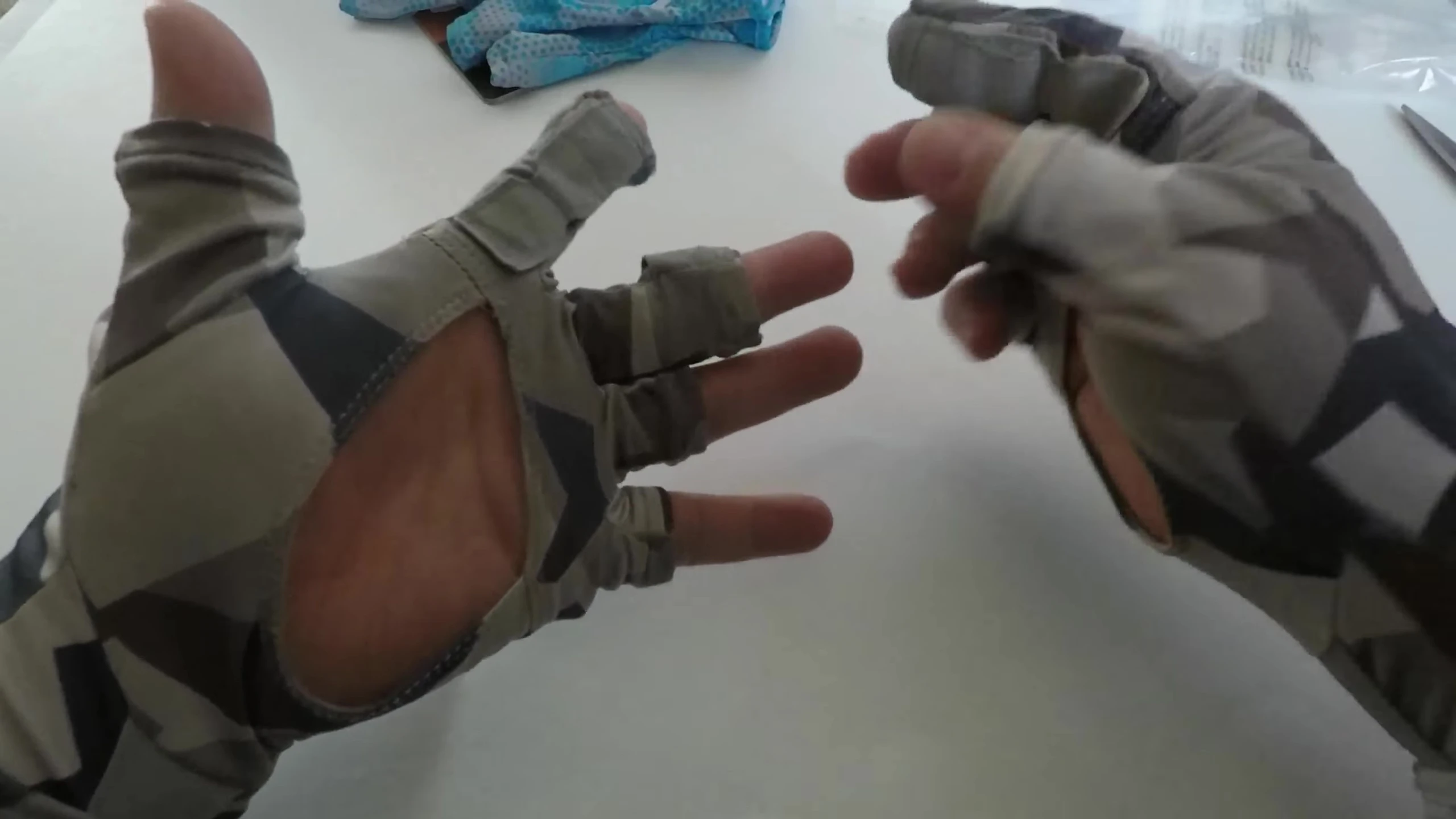 The reviewer shows his old gloves again for comparison.