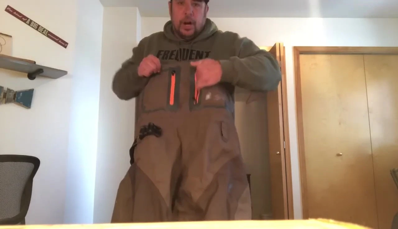 The reviewer showcasing the waterproof pockets.