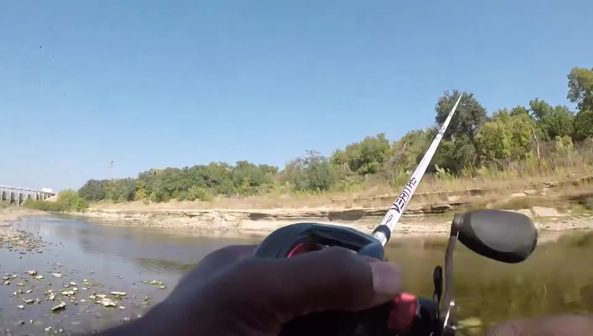 The presenter successfully catches a fish while wearing the waders.