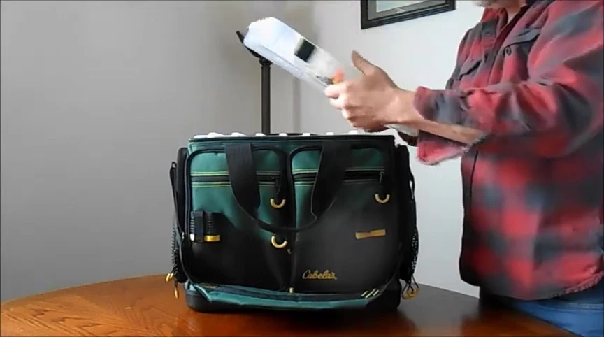 The tackle box with ice fishing tackle organized inside.