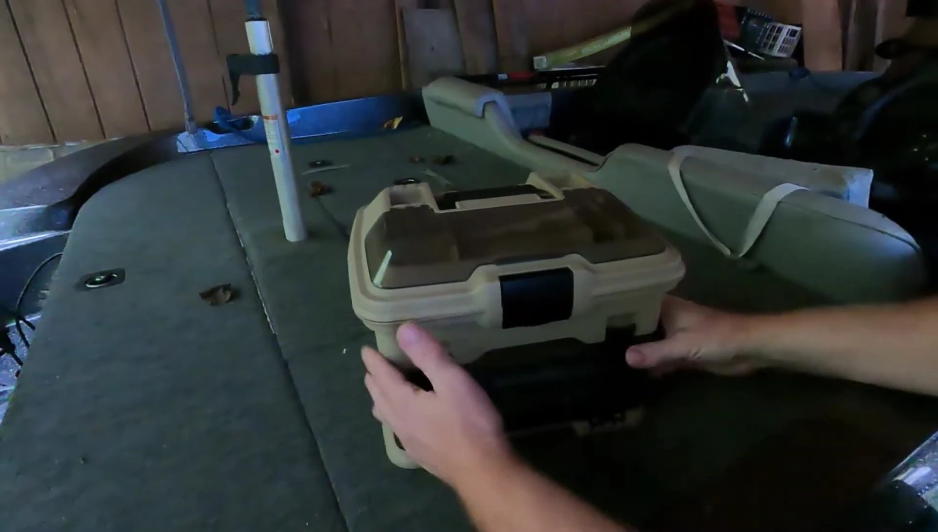 The smoke-colored tackle box with its flip-open lid.