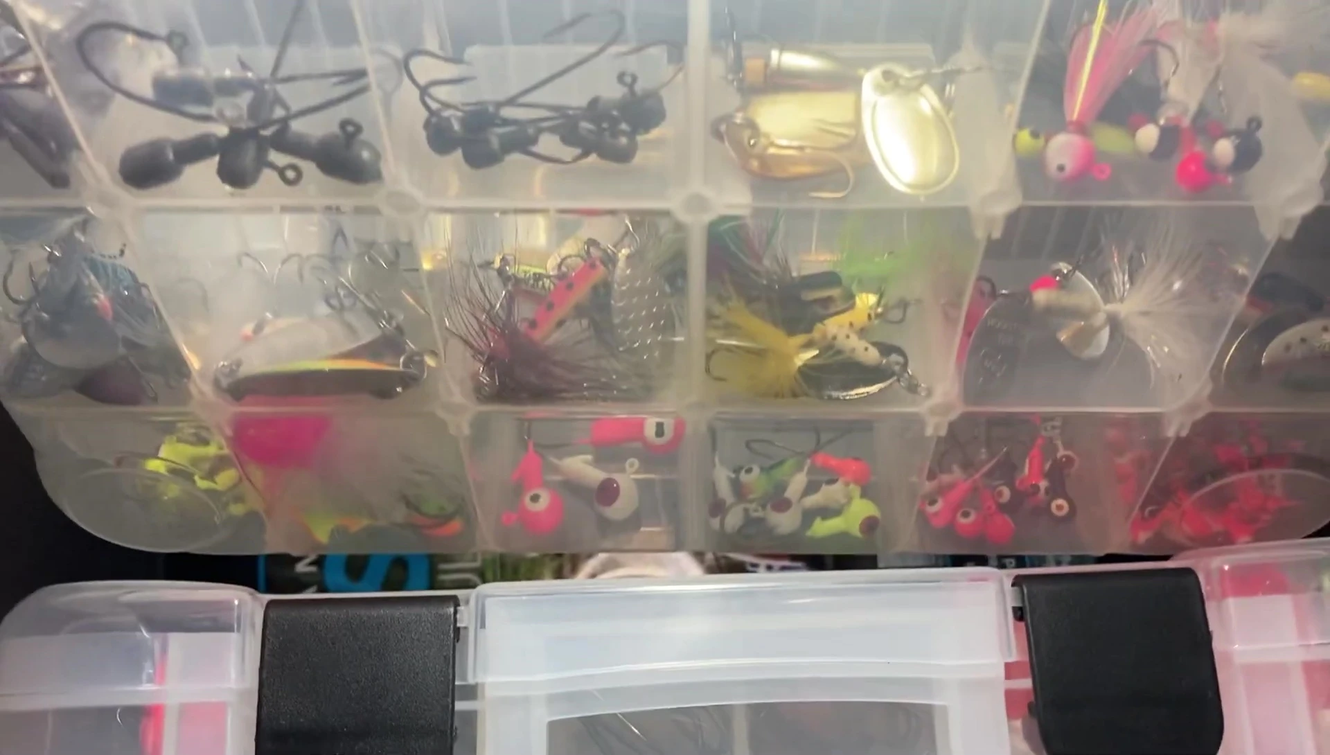 Inside the tackle box showing various lures and tackle.