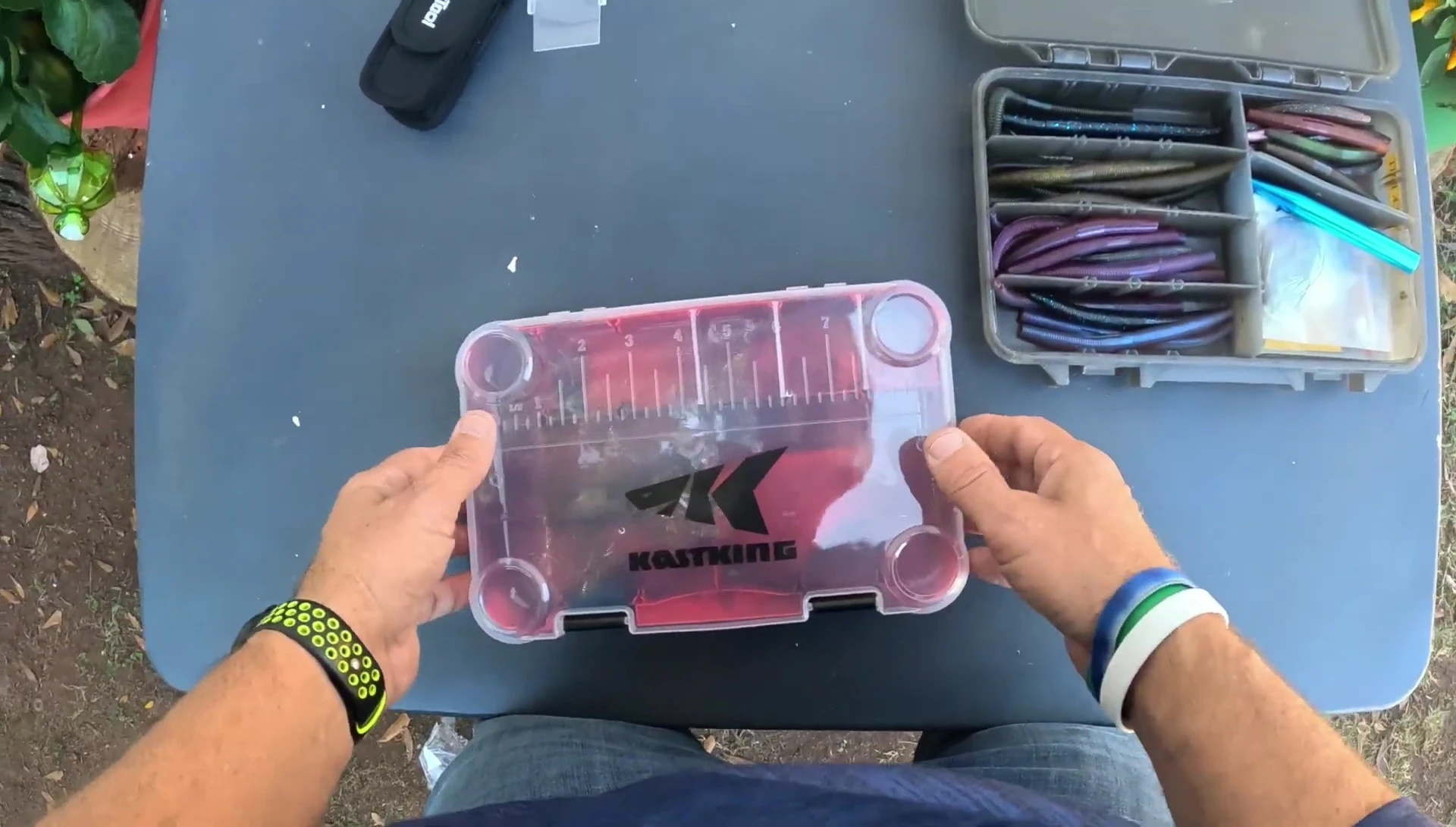 The process of transferring lures from the old Plano box to the KastKing Bait Vault.