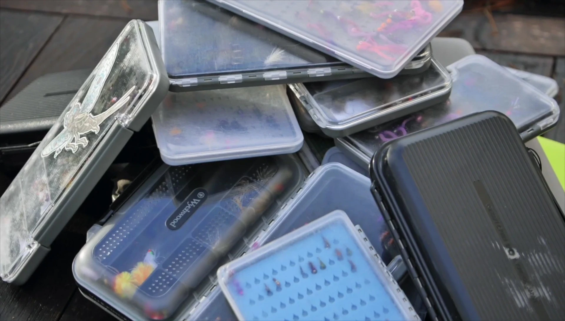A collection of fly boxes displayed on a table