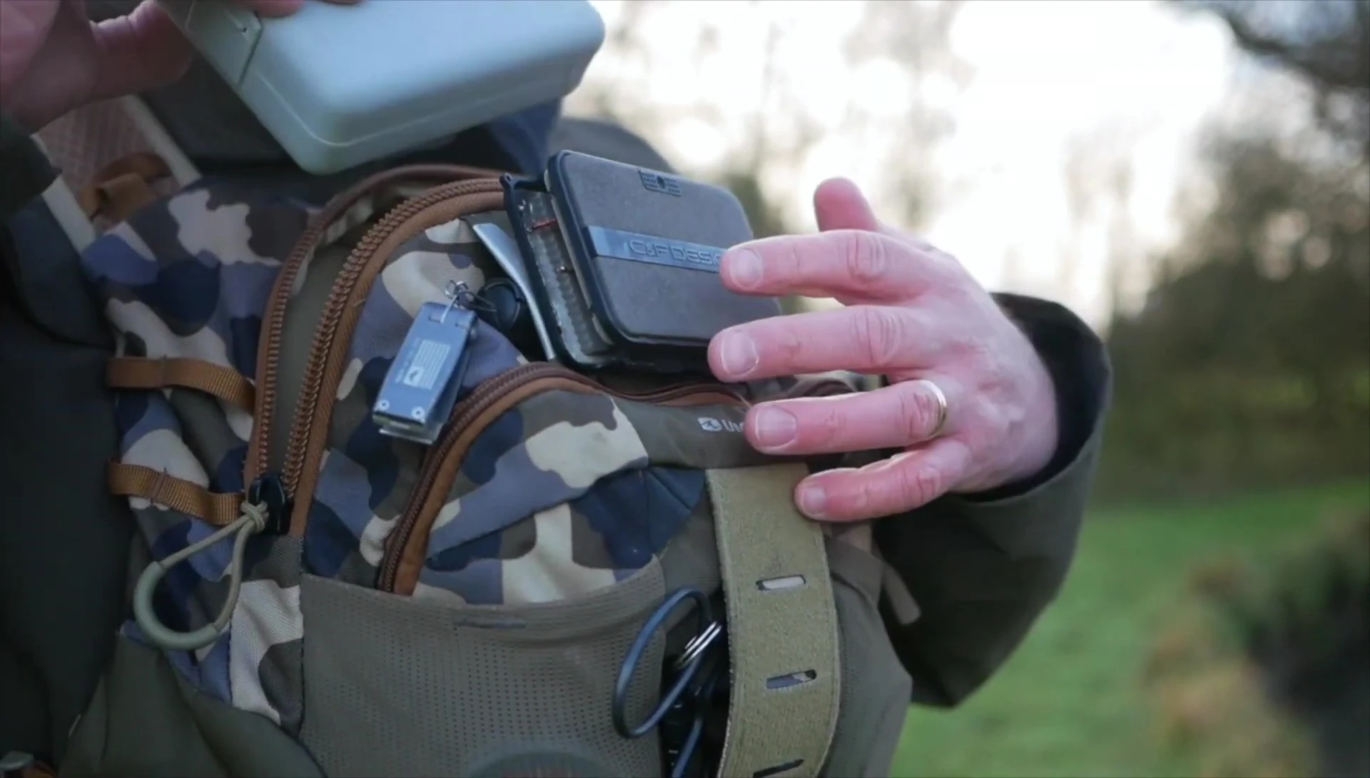 The fly box being placed into a chest pack