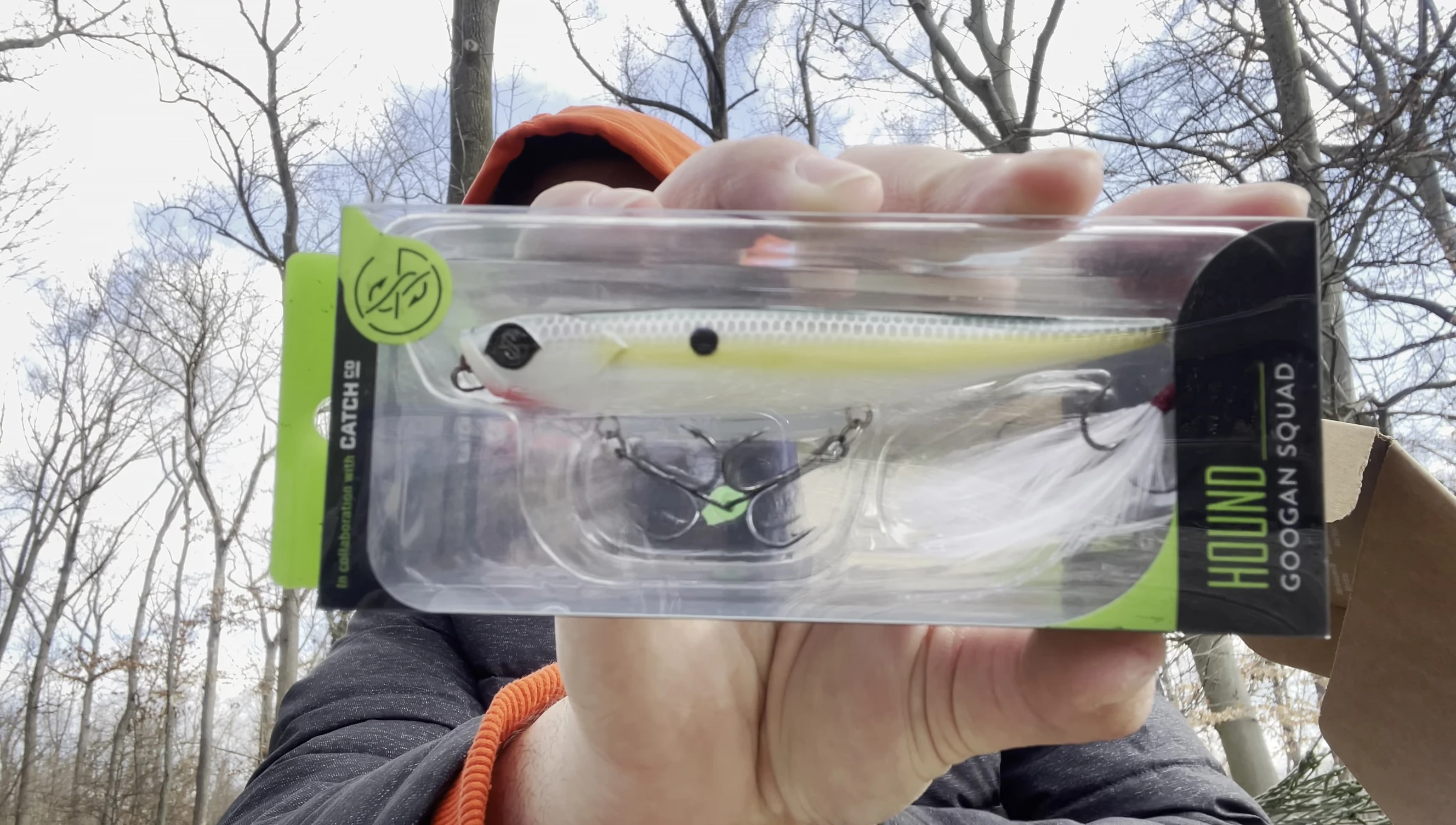 The angler takes the Googan Squad Hound out of its packaging.