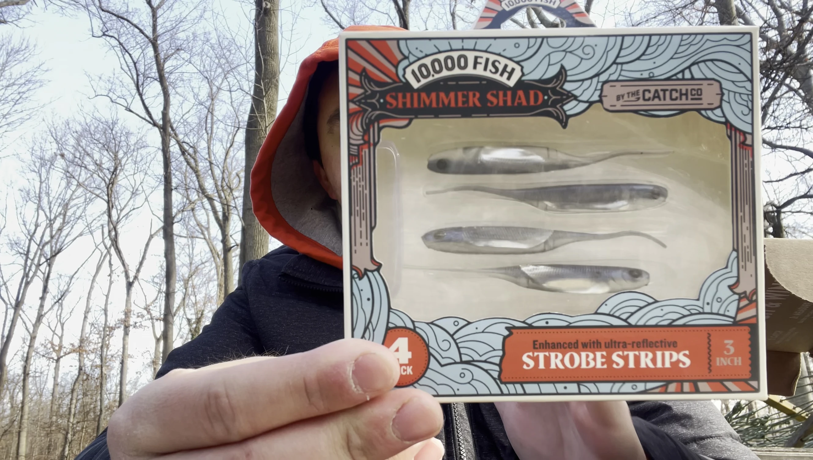 The angler shows the 10,000 Fish Shimmer Shad.