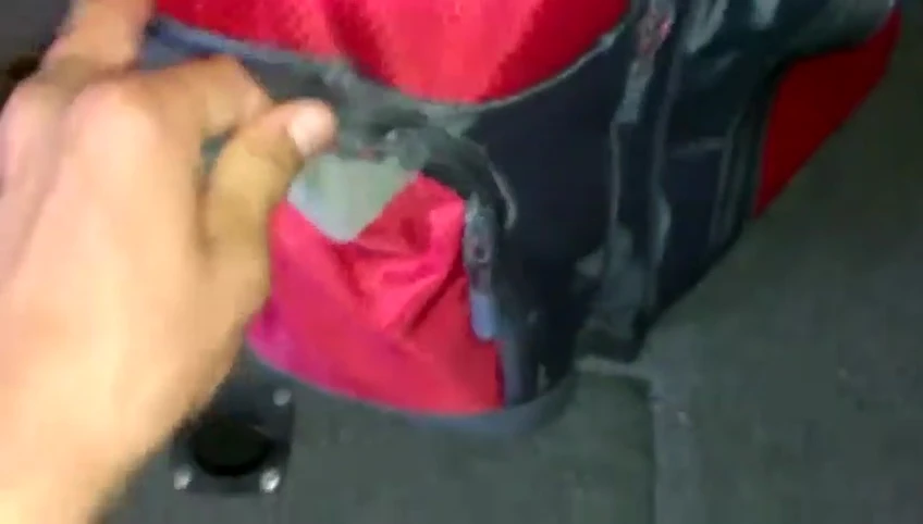 The reviewer opening the smaller side compartment.