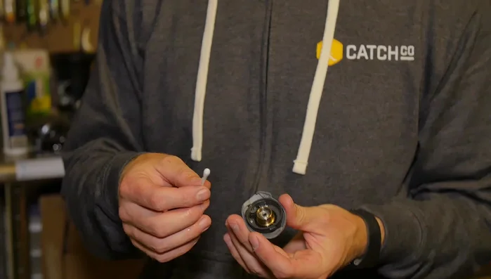 Clean side plates: Use a Q-tip and cleaner (or alcohol) to wipe down the raceways inside the side plates.