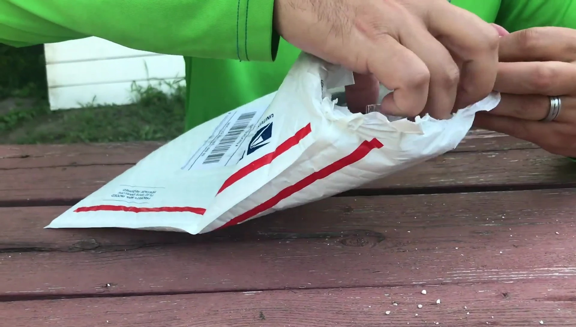 The presenter holding the storage bag for the gloves.