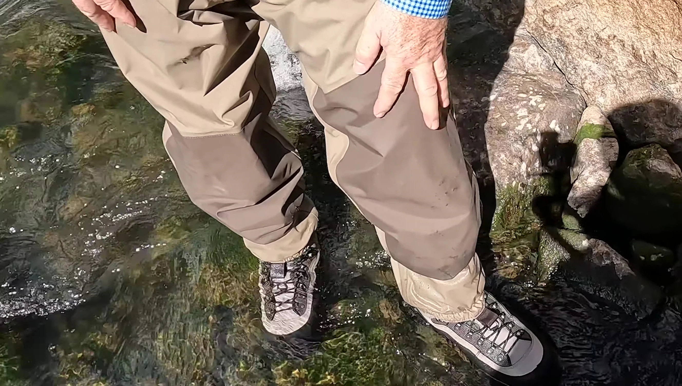 Close-up on the reinforced knee area of the waders.