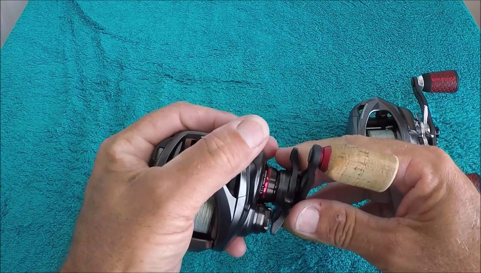 The reviewer demonstrating palming the Daiwa Steez reel.