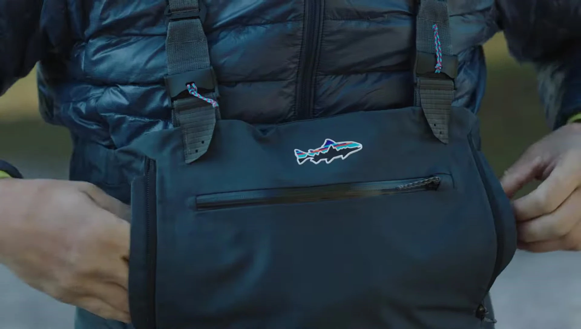 View of the large horizontal chest pocket with water-resistant zip.