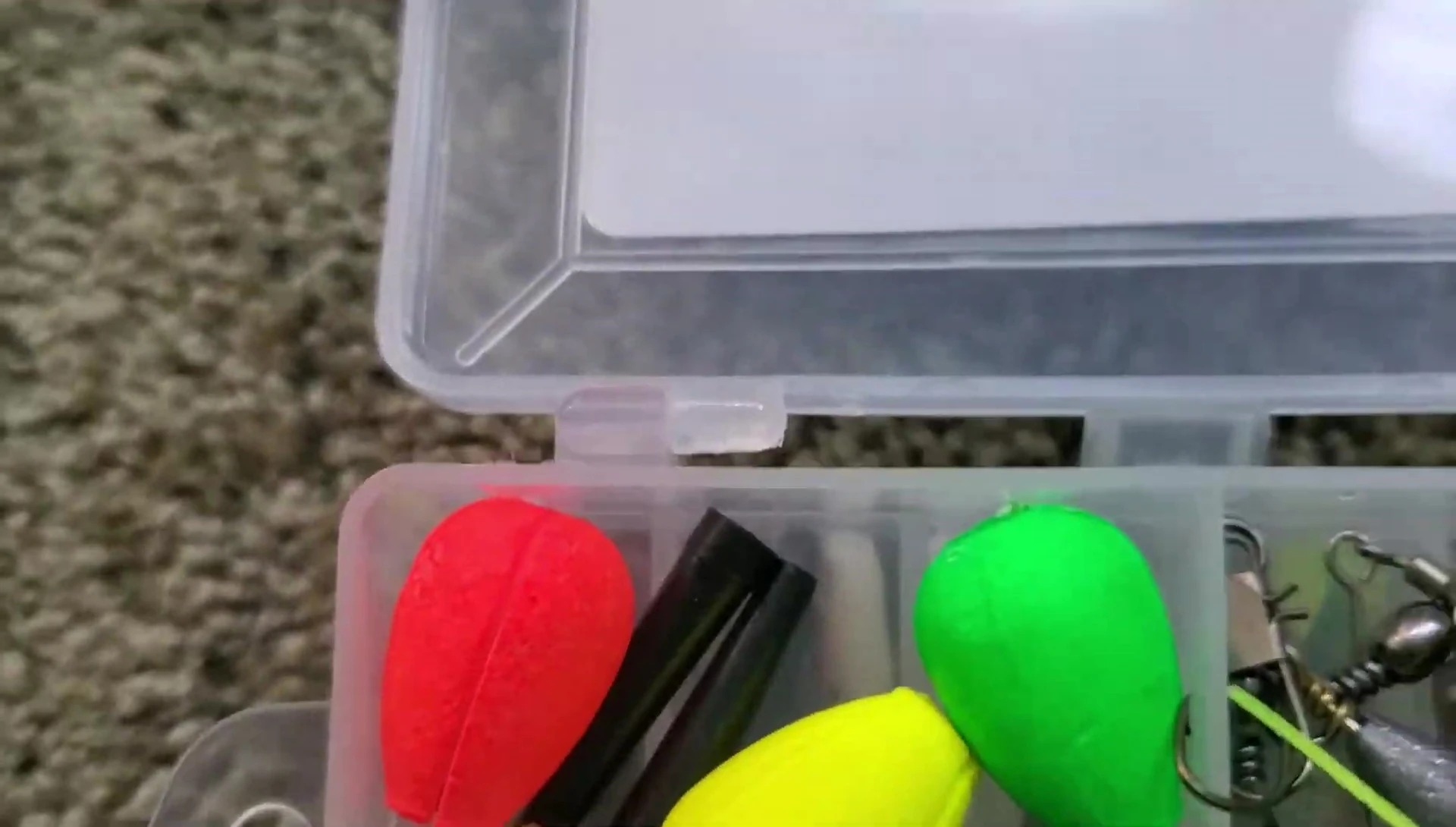 Close-up of the top compartment with various fishing accessories.