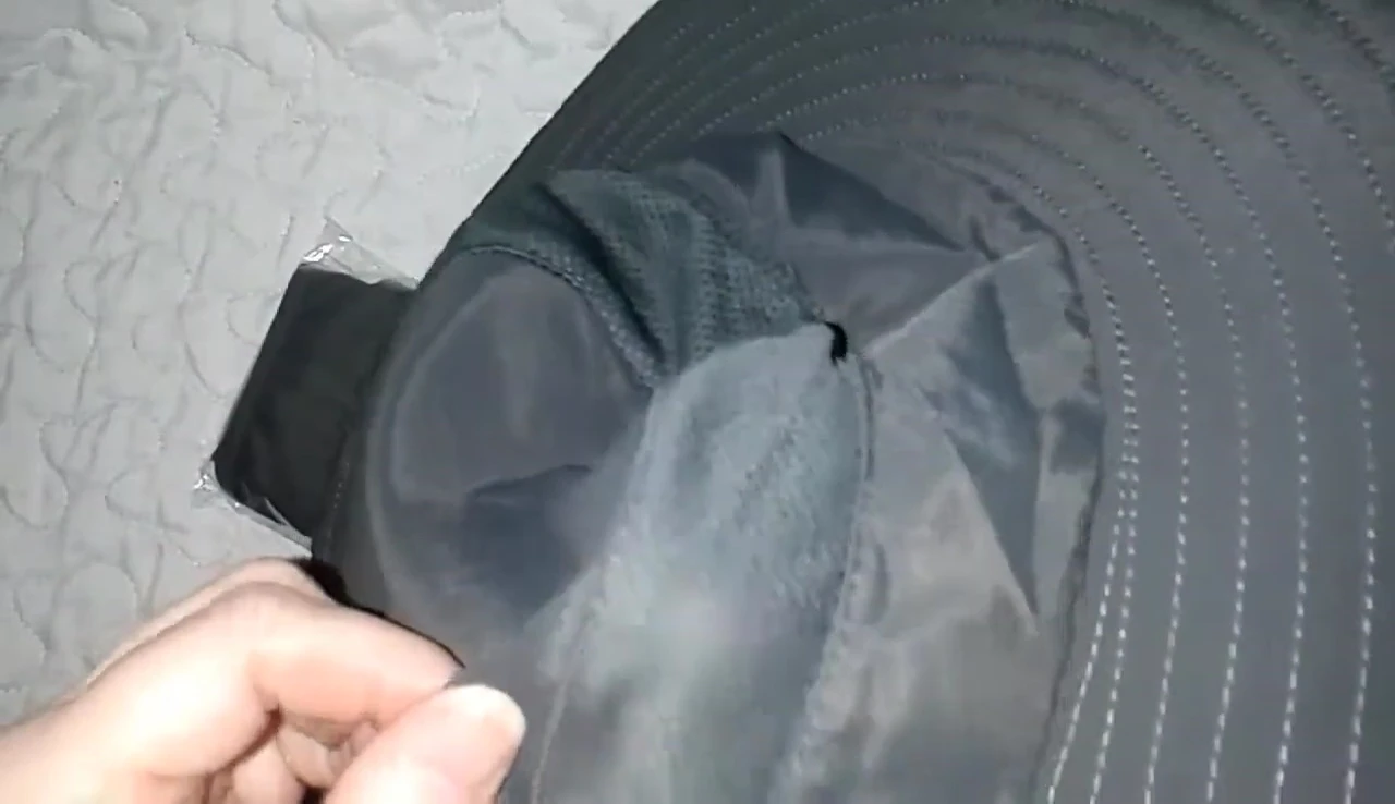 Highlighting the breathable mesh panels on the sides of the hat.