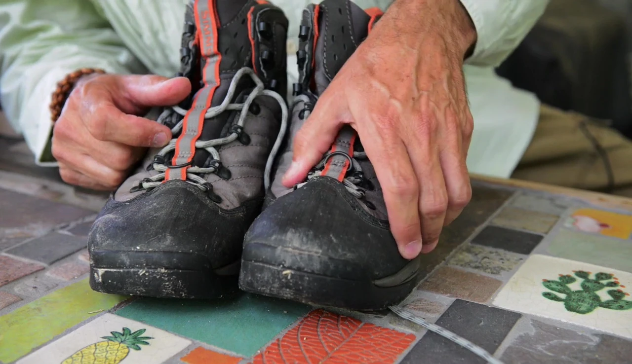 The reviewer showing the inside of the boot and adding heel inserts