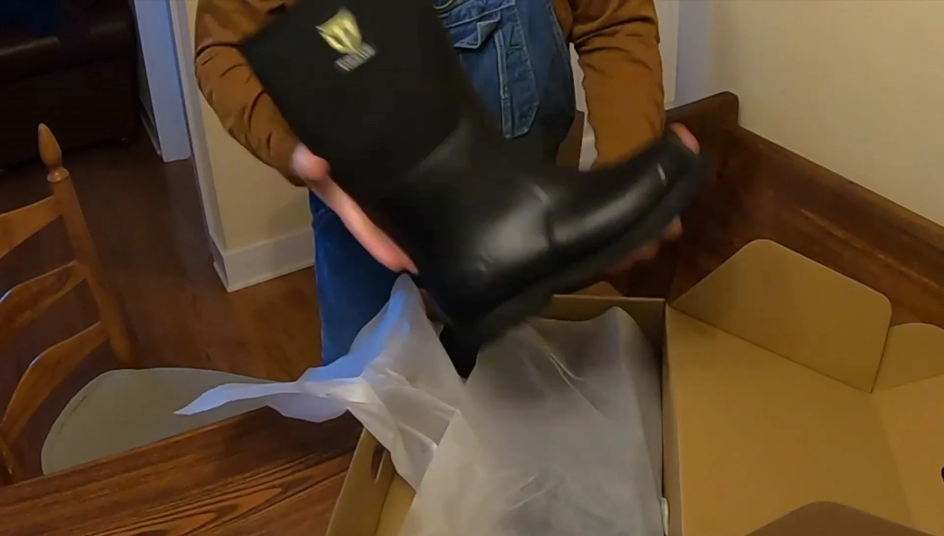 The reviewer shows the boots, highlighting the neoprene top and lug sole.
