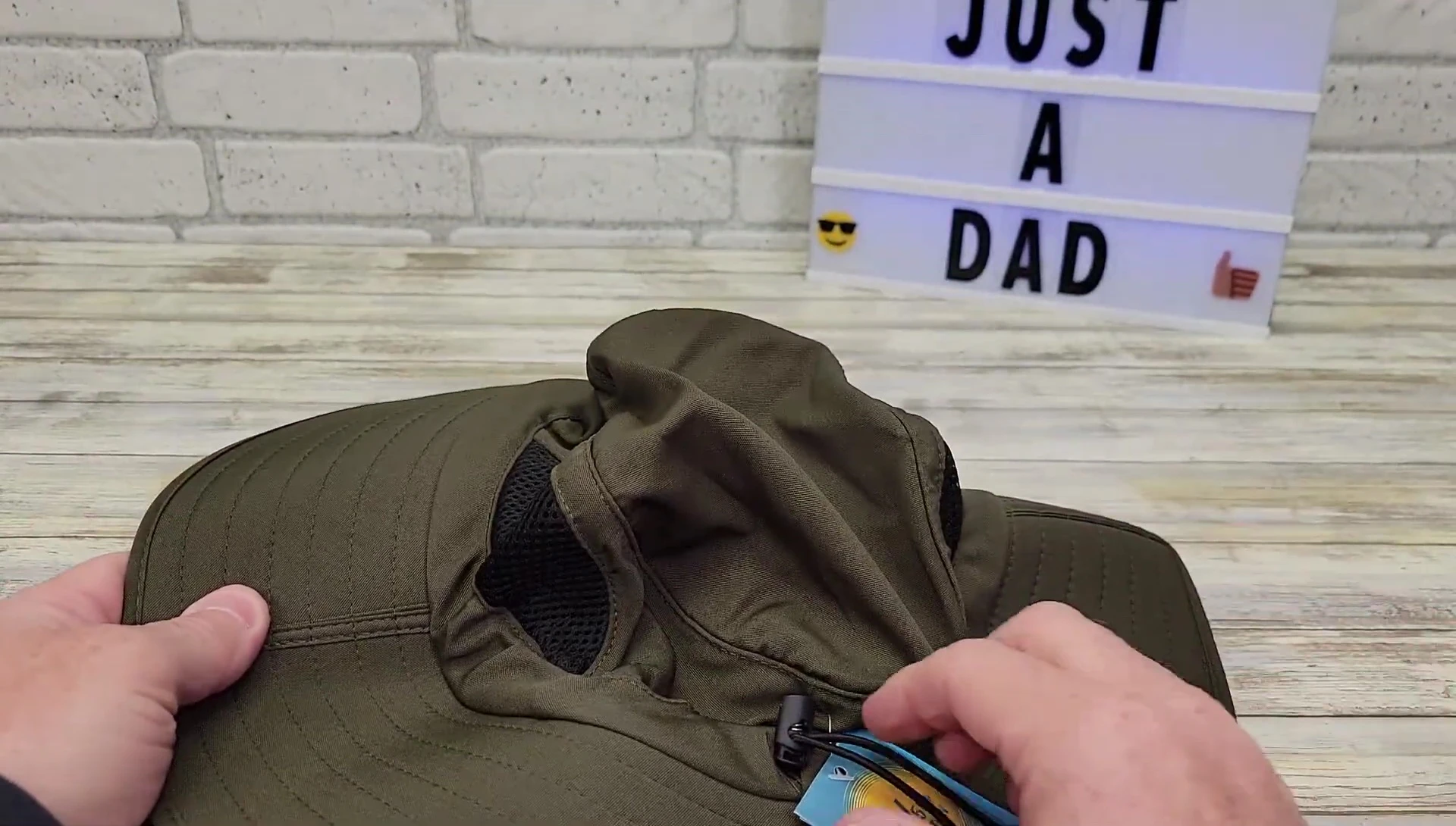 Close-up showing the adjustable straps on the hat.