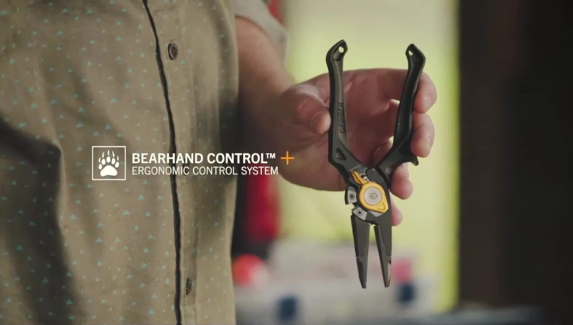 Hand interacting with the Gerber Magnifier handles, showcasing the ergonomic design.