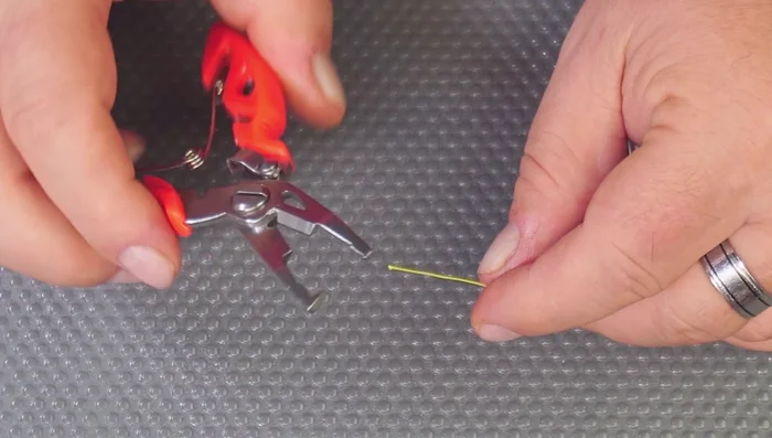 Testing Two-for-One Fishing Pliers' Cutting Capabilities: Successfully cuts braid and fishing line. Demonstrates split ring functionality for changing lure hooks.
